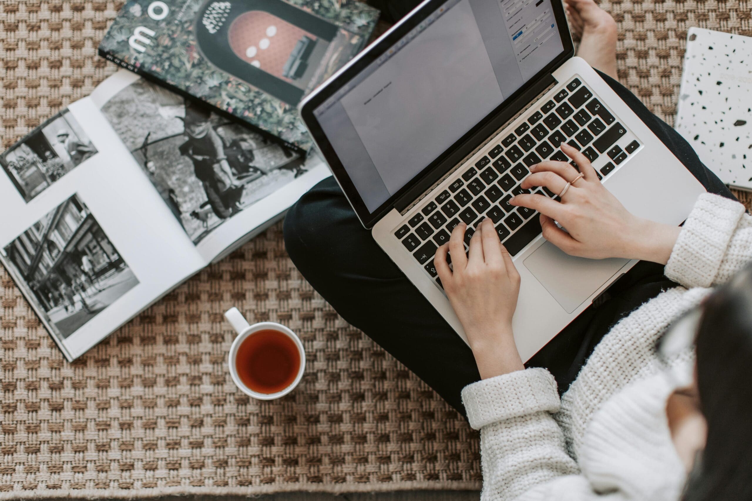 Female solopreneur working at her computer with a cup of tea