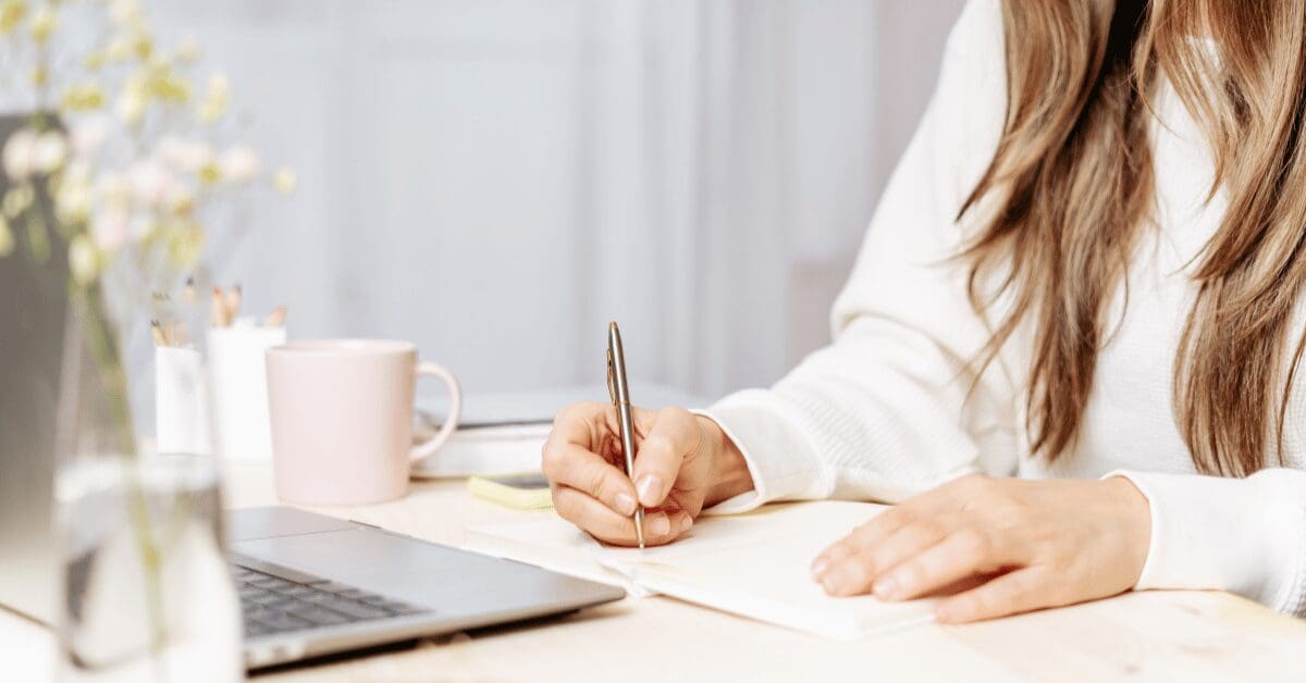 Woman writing a blog post to help with her website's SEO